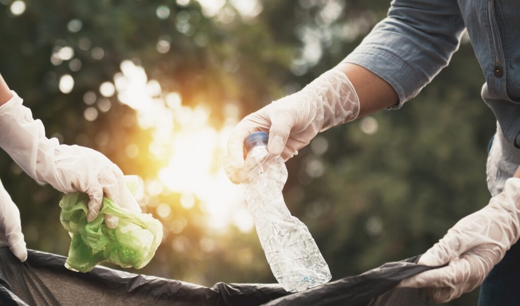 woman-hand-picking-up-garbage-plastic-cleaning-park.jpg